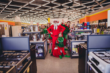 Full length body size view of attractive cheerful group elfs buying gifts presents eve bargain...