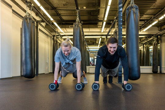 Young man and woman exercising in a gym