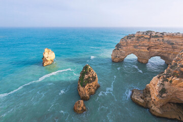 Portugal, Algarve, Lagoa, Praia da Marinha, rocky coastline and heart-shaped rock in the sea