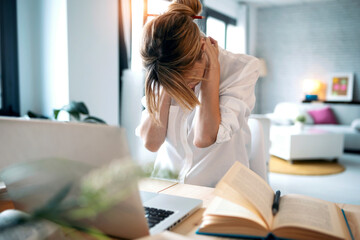 Tired woman working at home