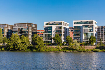 Modern apartments in front of river against clear sky at Frankfurt, Germany