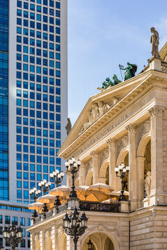 Low angle view of Frankfurt Old Opera House and skyscraper against sky, Germany