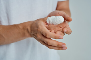 male patient hand injury treatment health problems light background