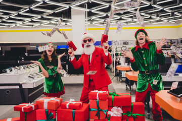 Portrait of attractive funky cheerful group elfs buying giftboxes shooting banknote credit loan...