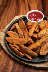 spicy curry powder coated crispy deep fried potato wedges