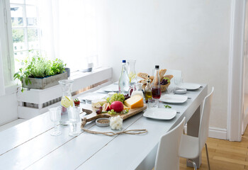 Laid table with fruit, cheese and bread
