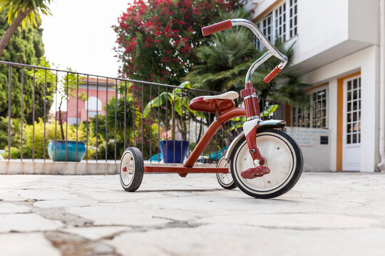 France, Alpes-Maritimes, Cagnes-sur-Mer, Red tricycle left outdoors