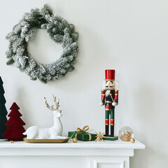 Christmas composition on the white chimney at the living room interior with beautiful decoration....