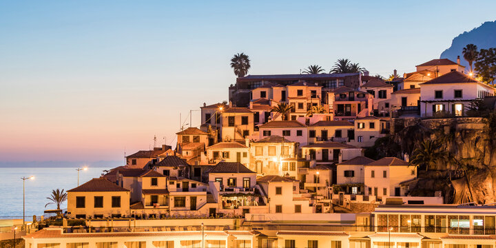 Portugal, Madeira,&Ocirc;&oslash;&Omega;Camara&Ocirc;&oslash;&Omega;de&Ocirc;&oslash;&Omega;Lobos, Hillside town houses at dusk