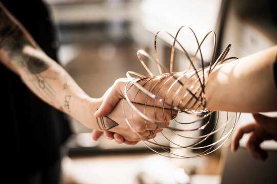 Designers playing with ring forms, shaking hands