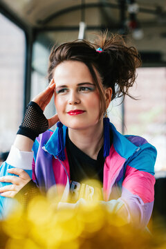 1980s retro-styled woman sitting in an old bus