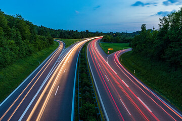 Germany, Baden-Wurttemberg, Blurred traffic lights on highway at dusk