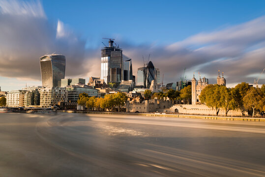 UK, London, City of London, River Thames, skyline with modern office buildings and Tower of London at sunset