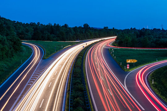 Germany, Baden-Wurttemberg, Blurred traffic lights on highway at dusk