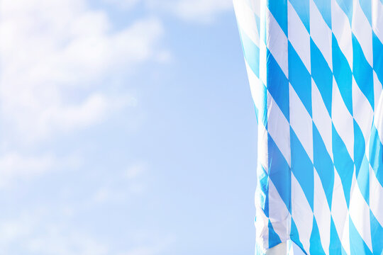 Germany, Bavaria, Munich, Low angle view of Bavarian flag hanging against sky during Oktoberfest