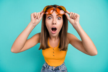 Photo of astonished amazed young woman reaction vacation summer sale cool lady isolated on teal...