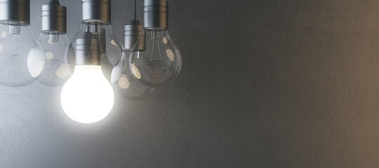 Glowing light bulb on blurry wide concrete wall background. Idea, innovation, solution and invention concept. Mock up, 3D Rendering.