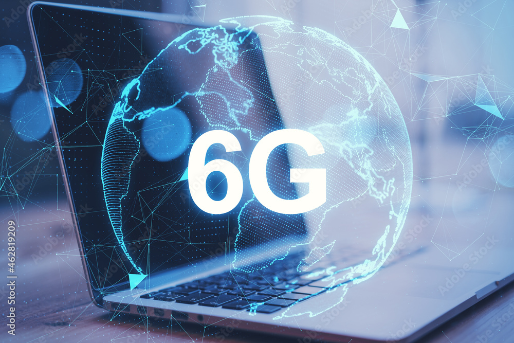 Poster close up of laptop with abstract globe 6g hologram on blurry background. technology, data and future