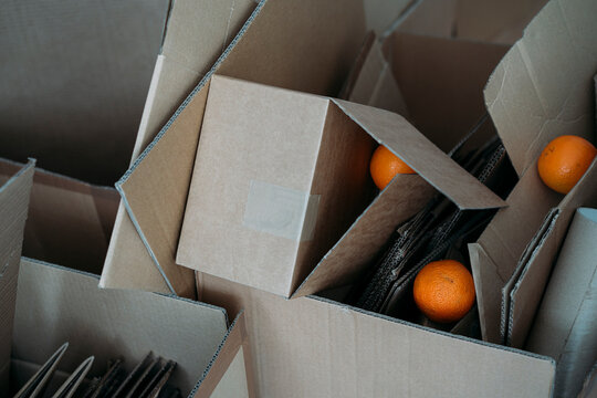 Three oranges on cardboard boxes