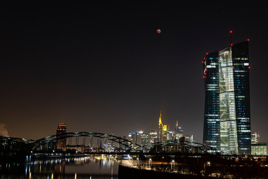 Germany, Frankfurt on Main, view to lighted skyline and European Central Bank at total lunar eclipse