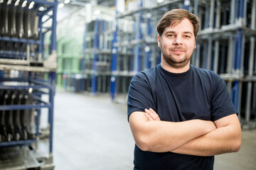 Portrait of confident worker in a factory warehouse