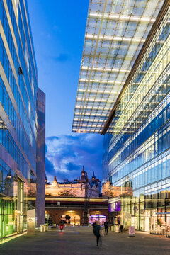 Germany, Berlin, Glass exteriors of Kurfurstendamm shopping malls at dusk