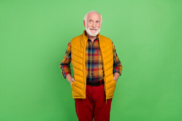 Photo of dreamy sweet mature man dressed yellow waistcoat smiling looking empty space isolated...