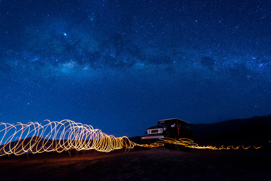 Indonesia, East Java, Spiral light trails in front of car parked in Bromo Tengger Semeru National Park at night