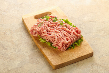 Raw minced pork meat over board