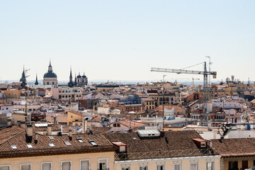 View of the La Latina neighborhood, in Madrid, the roofs of the houses and a crane in a day without pollution