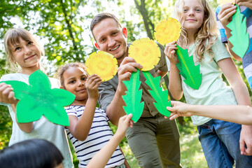 School children learning to to distinguish different leaf shapes