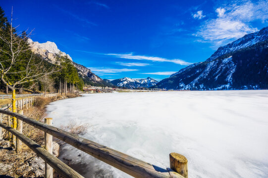 Austria, Tyrol, Shore of frozen Haldensee lake