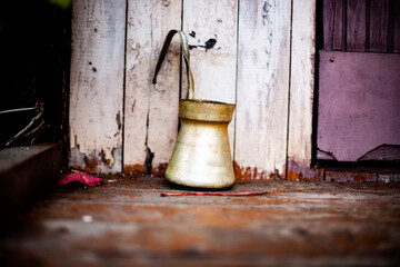 an old coffee pot on a wooden porch