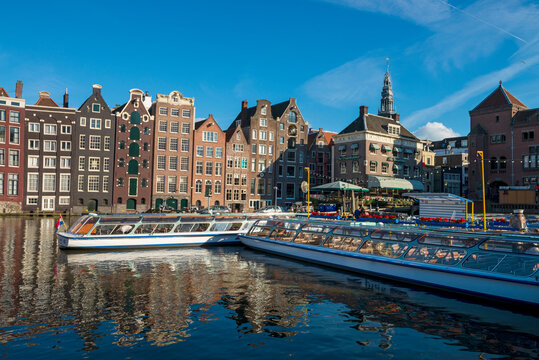 The Netherlands, North Holland Province, Amsterdam, Damrak, Tourboats and port buildings