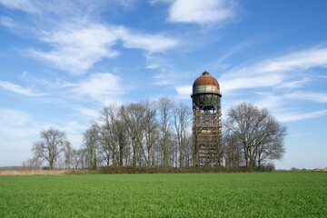 Germany, North Rhine-Westphalia, Ruhr, Grassy field with Lanstroper Ei water tower in background