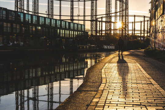 United Kingdom, England, London, man standing at Regent's canal against the evening sun