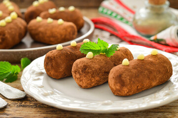 Potato cake on a white plate decorated with a sprig of mint. Russian dessert.