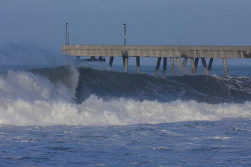 large surf waves at Sharp Park pier. California. USA