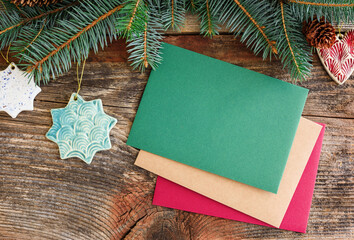 Christmas background concept. Multicolored cards. Christmas tree branches with cones.