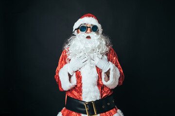 Man dressed as Santa Claus wearing Victorian style welder goggles, on black background. Christmas concept, Santa Claus, gifts, celebration.
