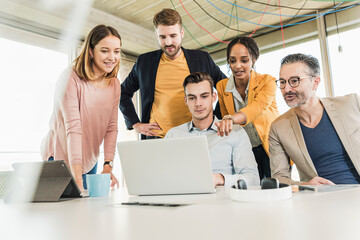 Business people having a meeting in office using laptop