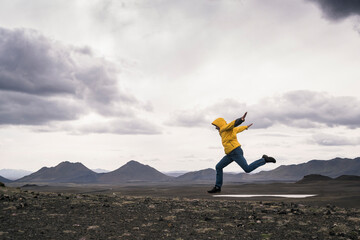 Mature man jumping for joy in the Highland Region, Iceland