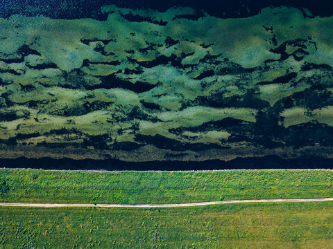 Aerial view of isthmus and dirt road stretching along coast of Krabbe Peninsula
