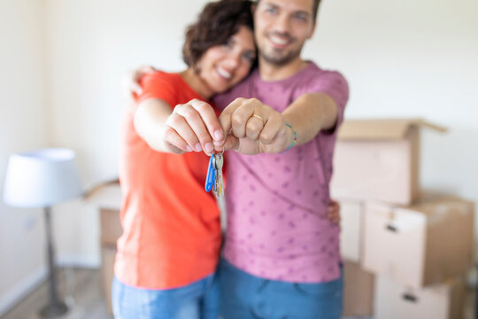 Happy couple showing the keys of the new home
