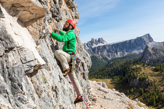 Italy, Cortina d'Ampezzo, man climbing in the Dolomites mountains