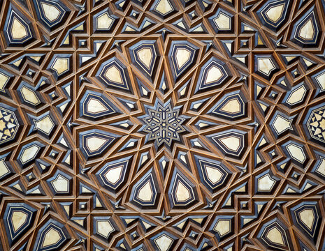 Closeup of wooden arabesque decorations tongue and groove assembled, inlaid with ivory and ebony, on Minbar of historic public Mosque of Al Rifai, Old Cairo, Egypt