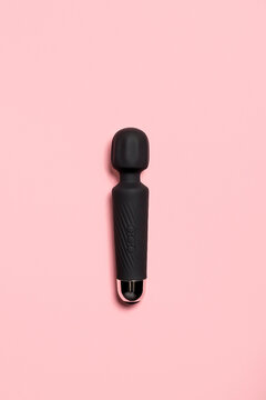 Black sex toy against pink background