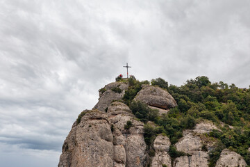 Naklejka premium The Cross of San Miguel, is located at the top of the path of San Miguel on the mountain of Montserrat next to the monastery