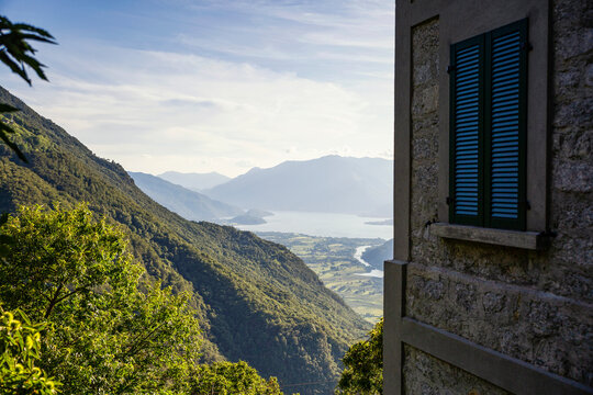 Italy, Province of Sondrio, Corner of building overlooking valley in Riserva Naturale Pian di Spagna e Lago di Mezzola
