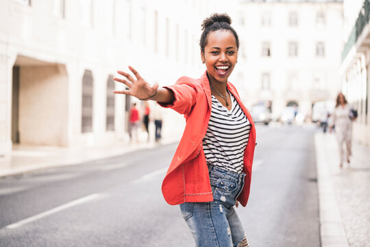 Portrait of happy young woman in the city, Lisbon, Portugal